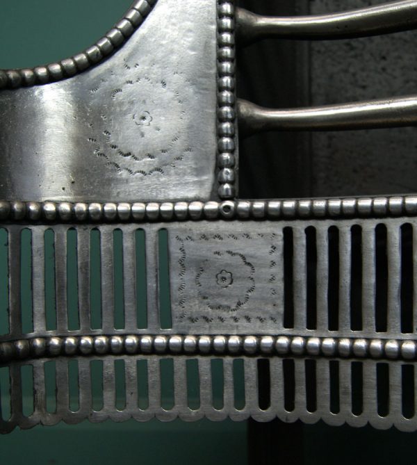 A Polished Steel Dog Grate by T Elsley
