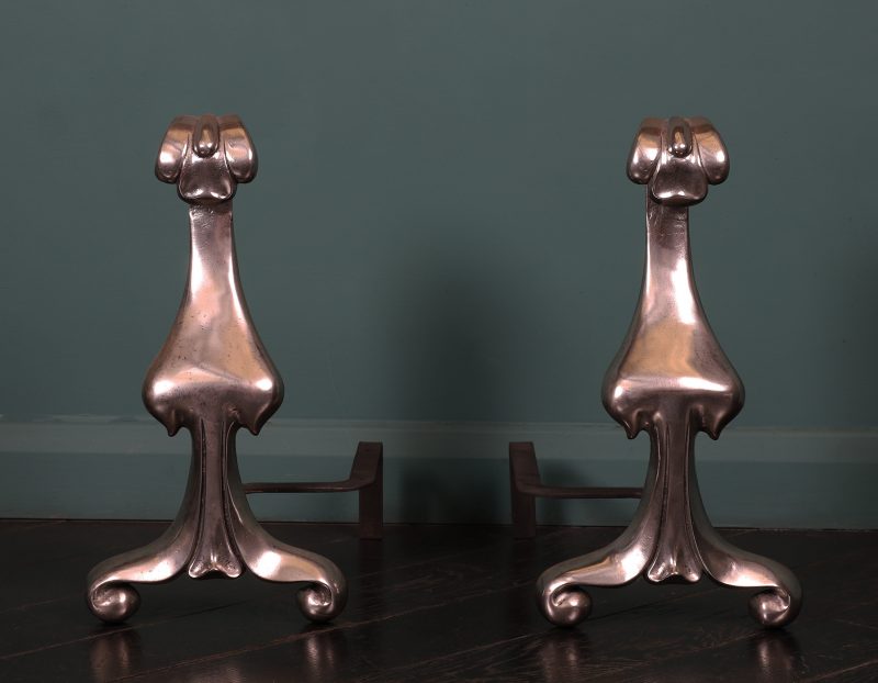 A Pair of Art Nouveau Polished Steel Fire Dogs