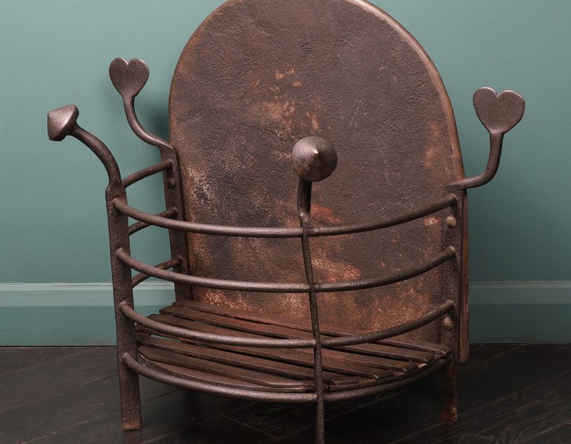 An Arts & Crafts Semi-Circular Wrought Fire Basket with Heart-Shaped finials
