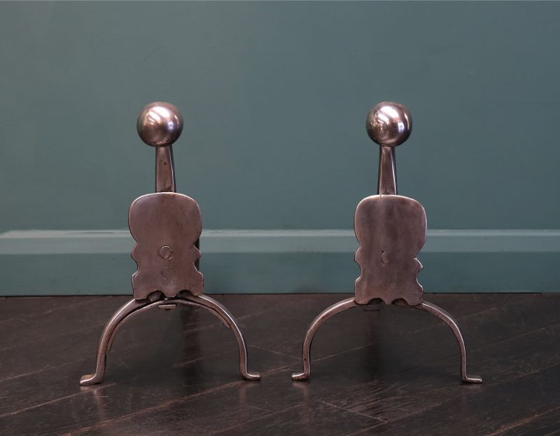 A Pair of Georgian Polished Wrought Fire Dogs with Shield