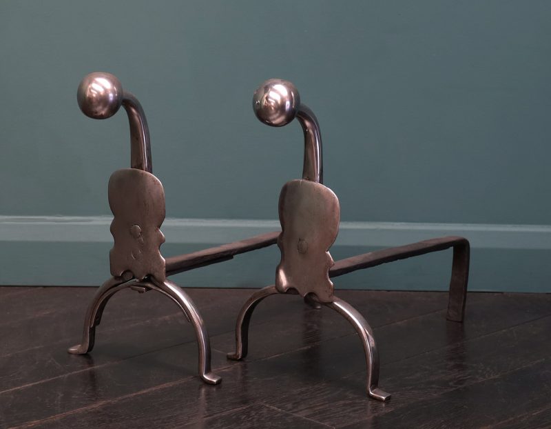 A Pair of Georgian Polished Wrought Fire Dogs with Shield