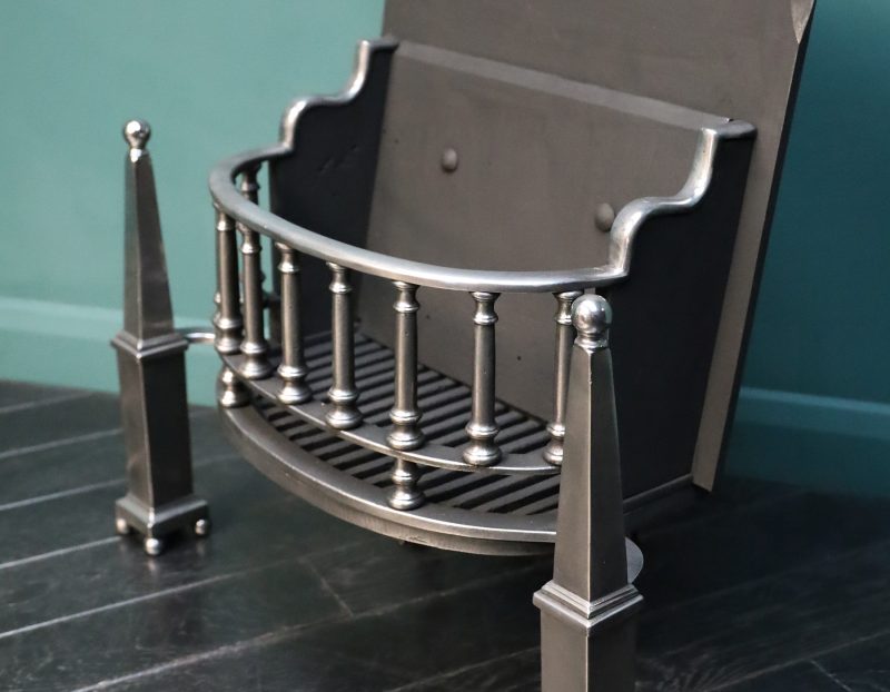 A Polished Steel Fire Grate with Pinnacle Finials